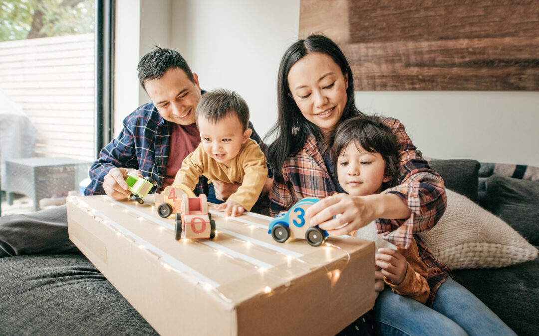 Parents with two kids, or their heirs, playing with toy cars while contemplating how their assets will eventually pass to their heirs