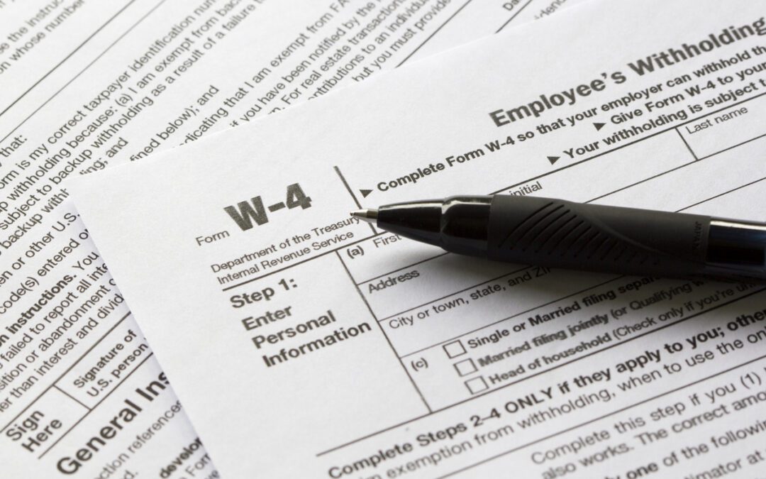 Upper left corner of a Form W-4 with a black pen laying on the form