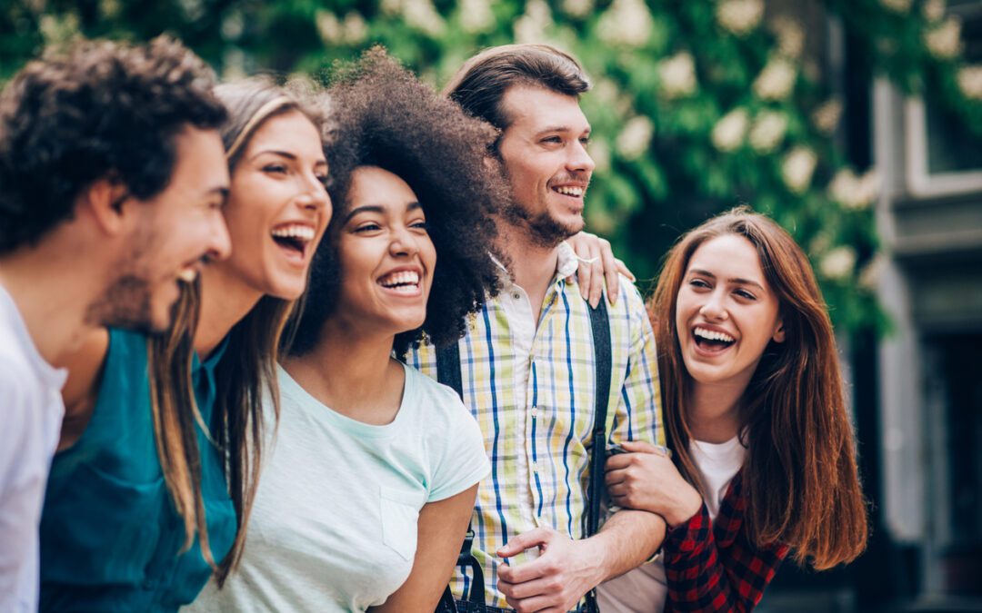 Group of five adults laughing with each other all with different investment personalities